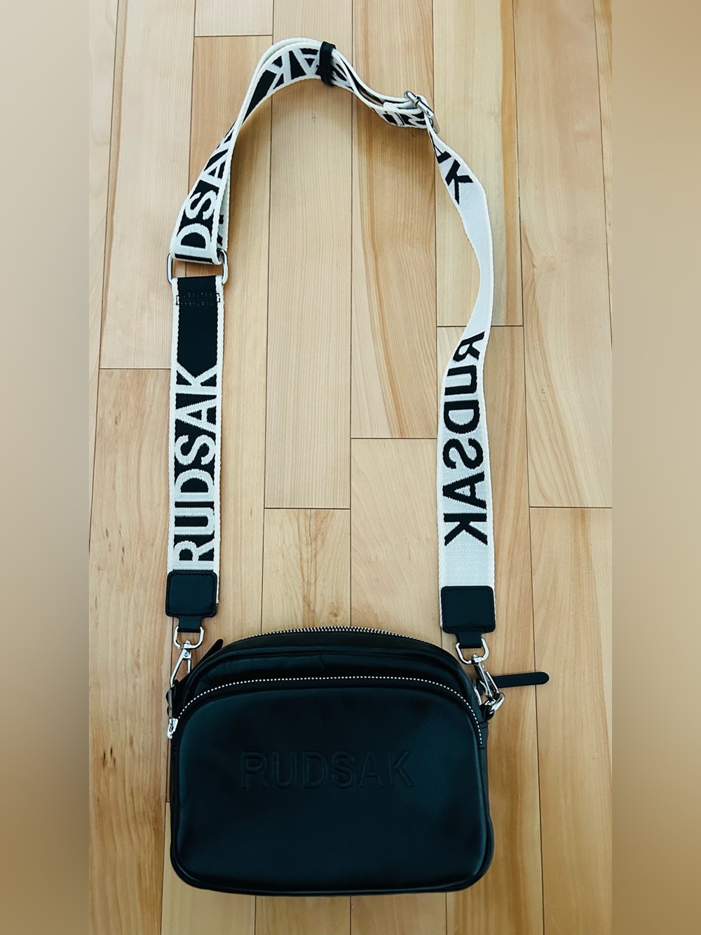 RUDSAK Black Crossbody Bag with White Branded Strap